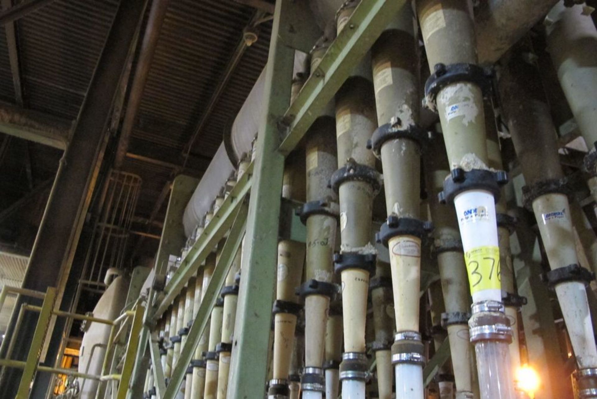 1 ROW OF ANDRITZ CENTRI-CLEANER LIQUID CYCLONE METAL CYLINDER BOTTLES, APPROX 20 IN ROW (BLDG 46