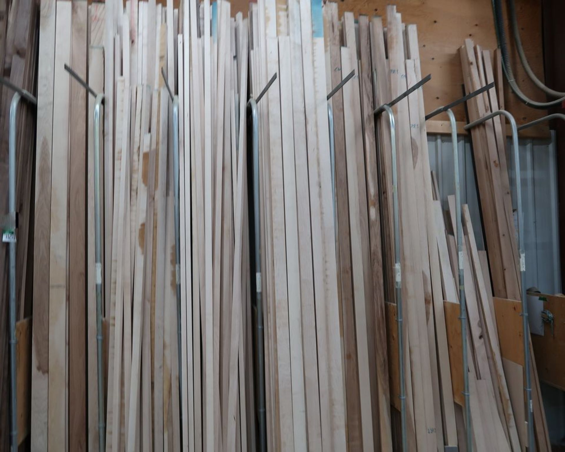 LOT OF ASST'D WOOD BOARD CUTS IN WALL RACK