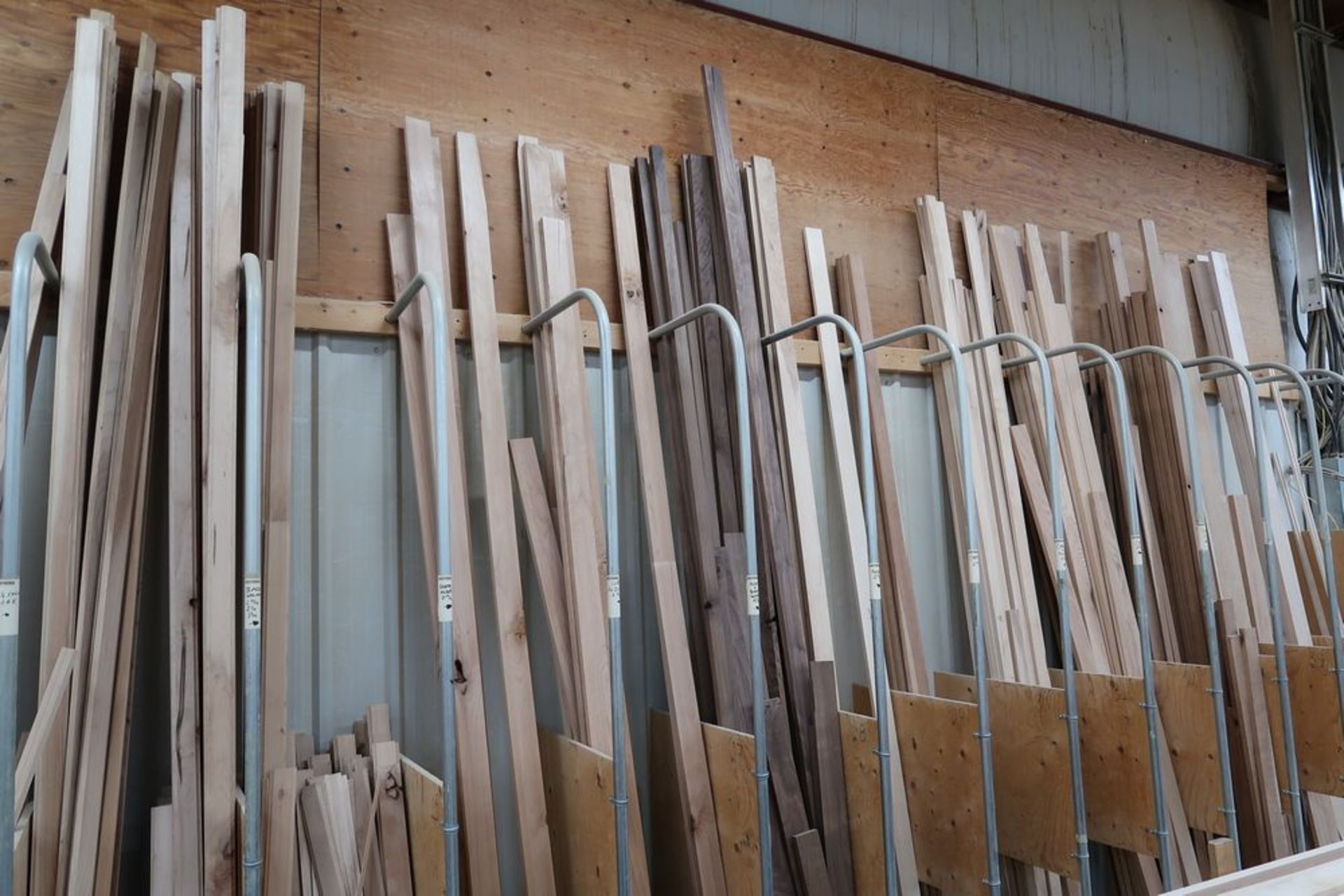 LOT OF ASST'D WOOD BOARD CUTS IN WALL RACK