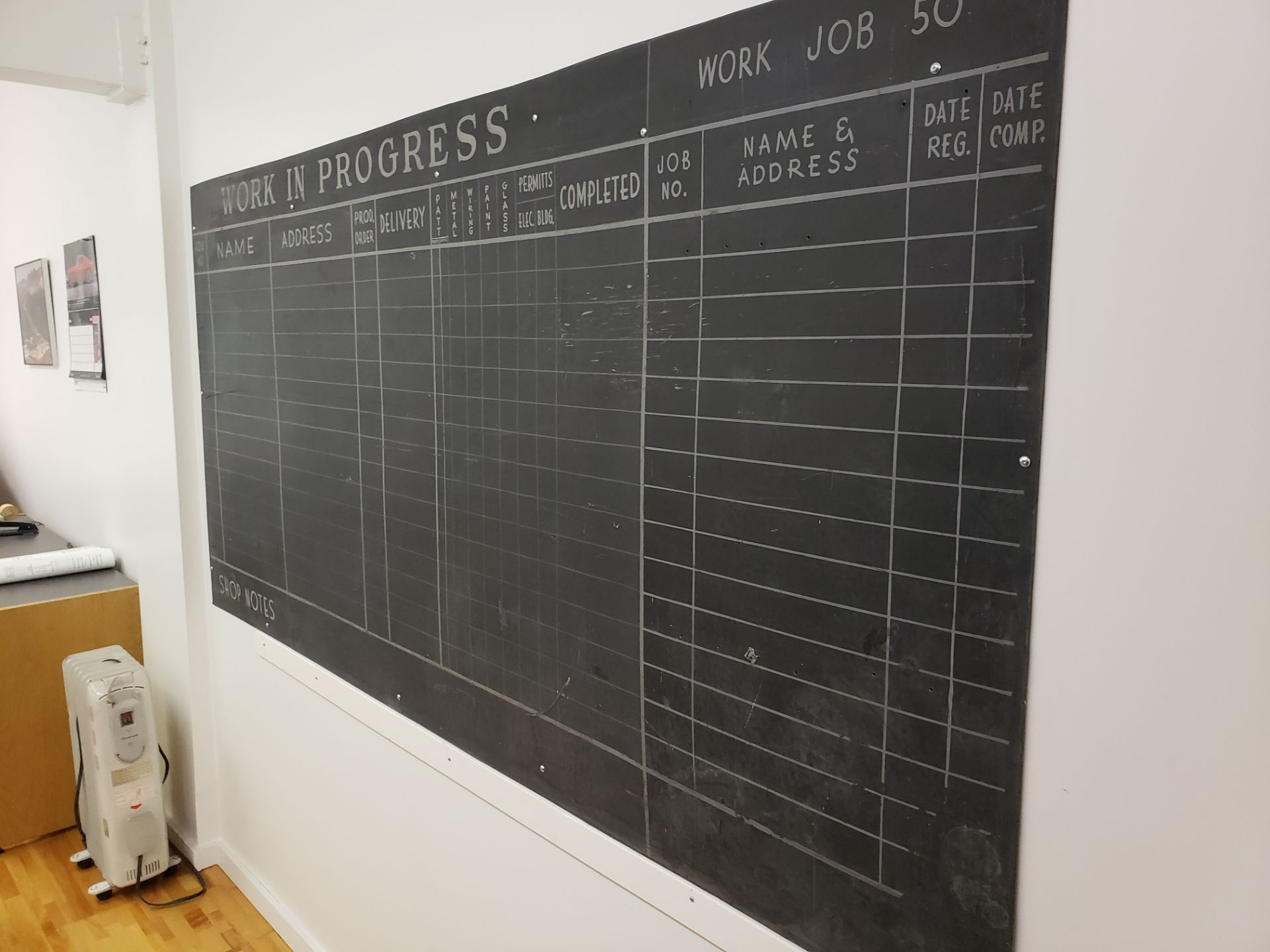 Approximate 4' x 8' blackboard on wall in office