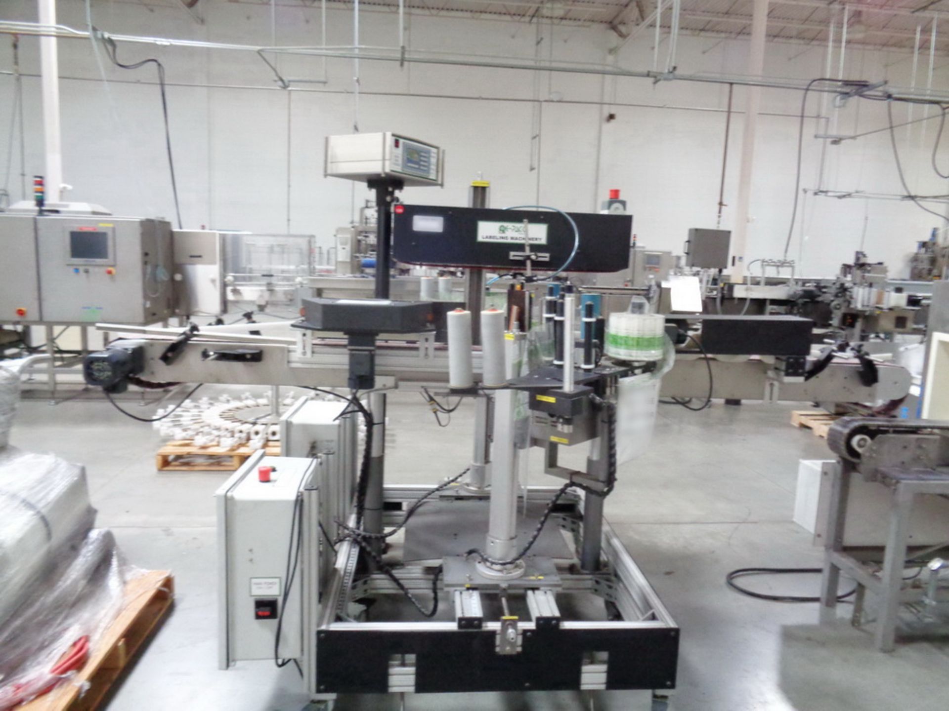 PE-Pack Double Sided Pressure Sensitive Wrap Labeler with conveyor.