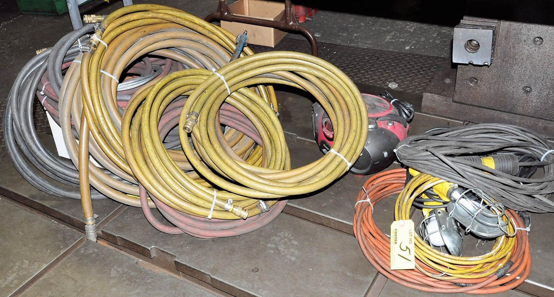 Lot of Air Hose, Extension Cords and Lights Under Table