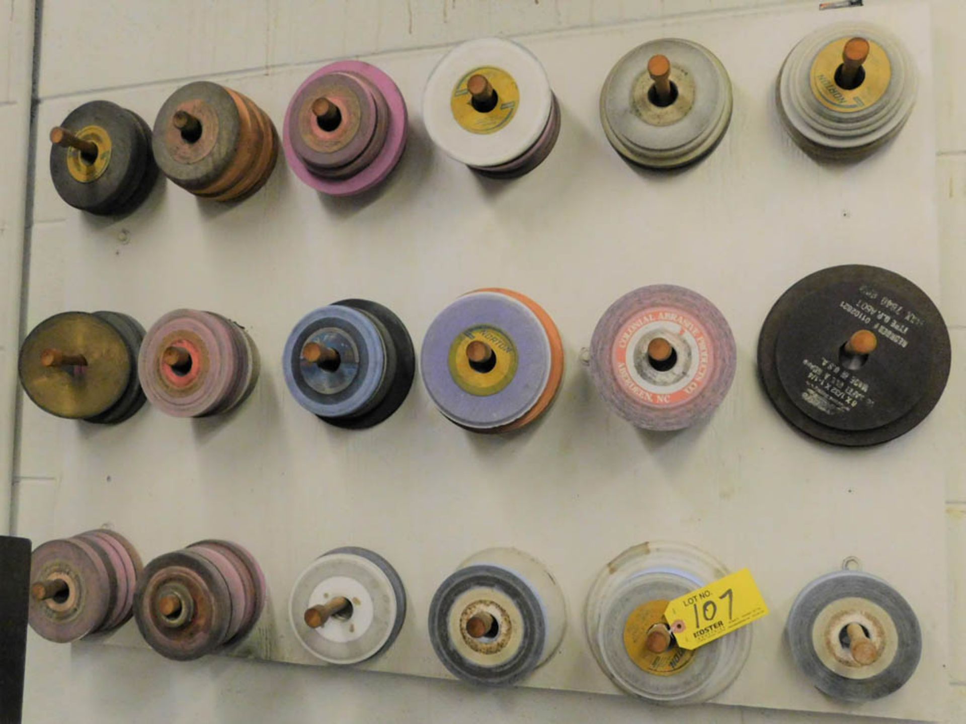LOT OF ASSORTED GRINDING WHEELS ON WALL