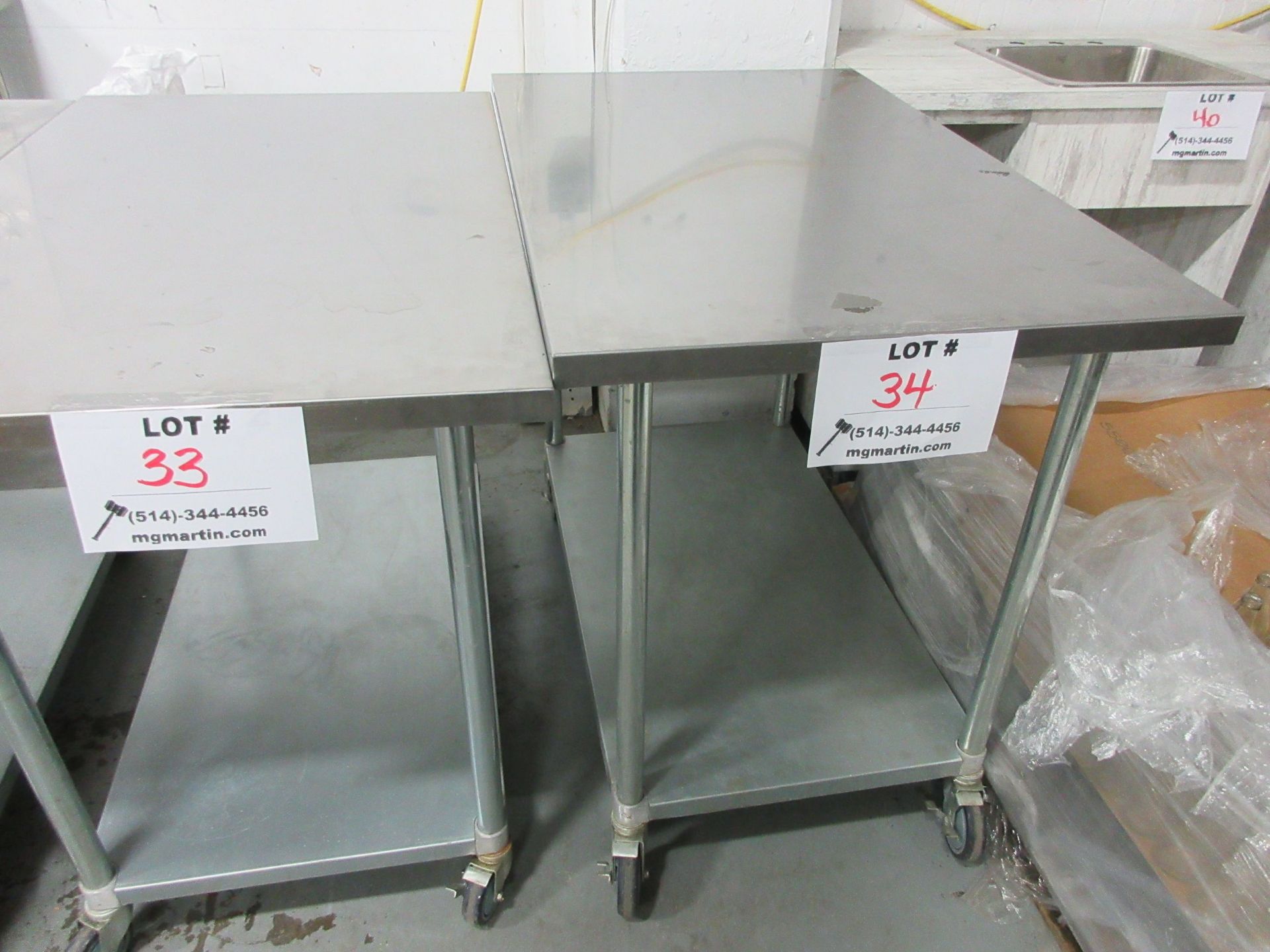 Stainless steel table 30" x 48" x 39" high (aprox) c/w wheels