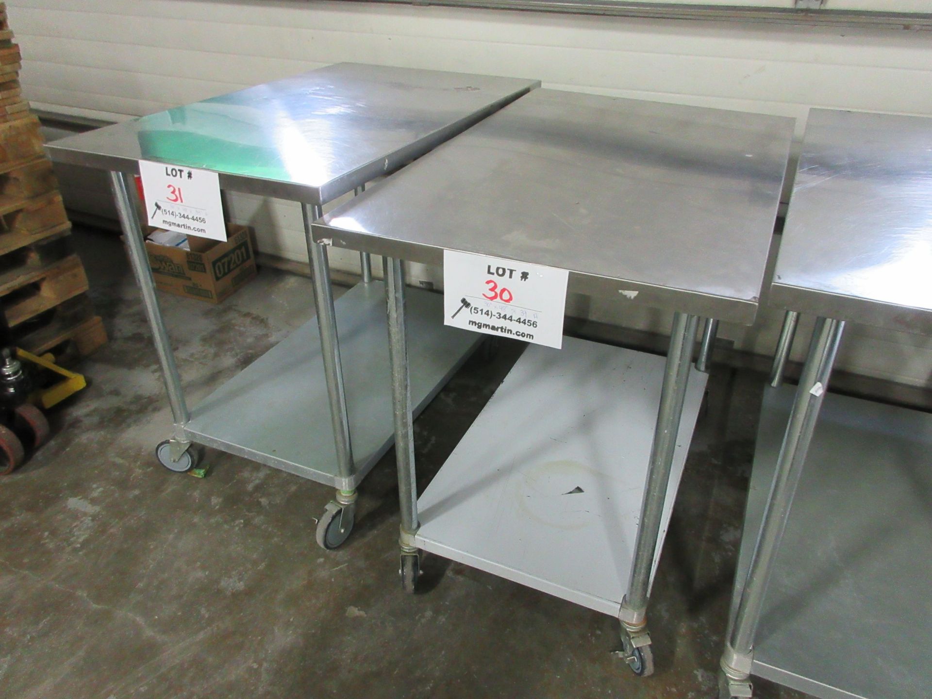 Stainless steel table 30" x 48" x 39" high (aprox) c/w wheels