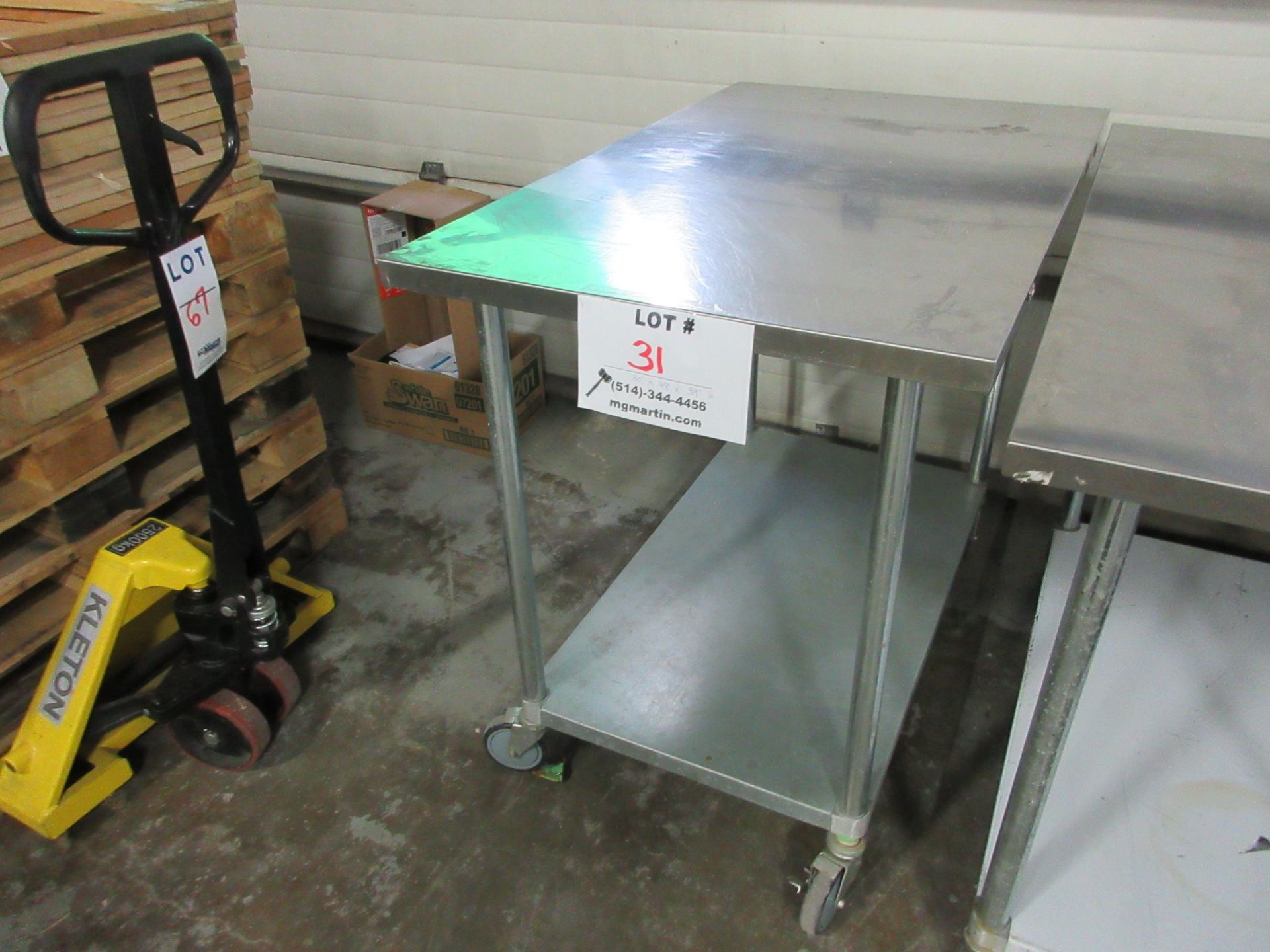 Stainless steel table 30" x 48" x 39" high (aprox) c/w wheels