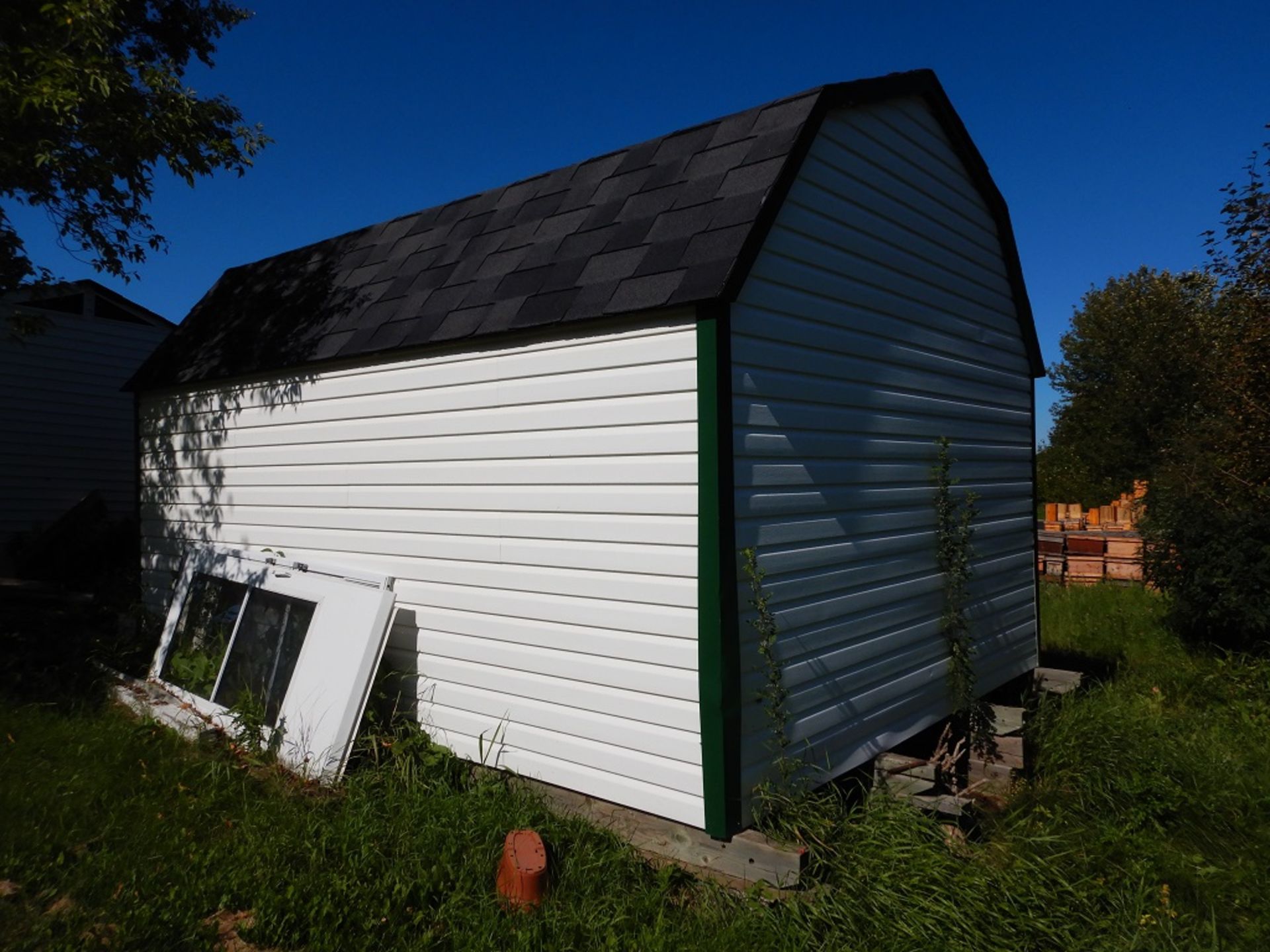 12'X16' SKIDDED HIP ROOF VINYL CLAD BUILDING W/ 7'X7' ROLL UP METAL DOOR, PARTIALLY INSULATED & - Image 2 of 3