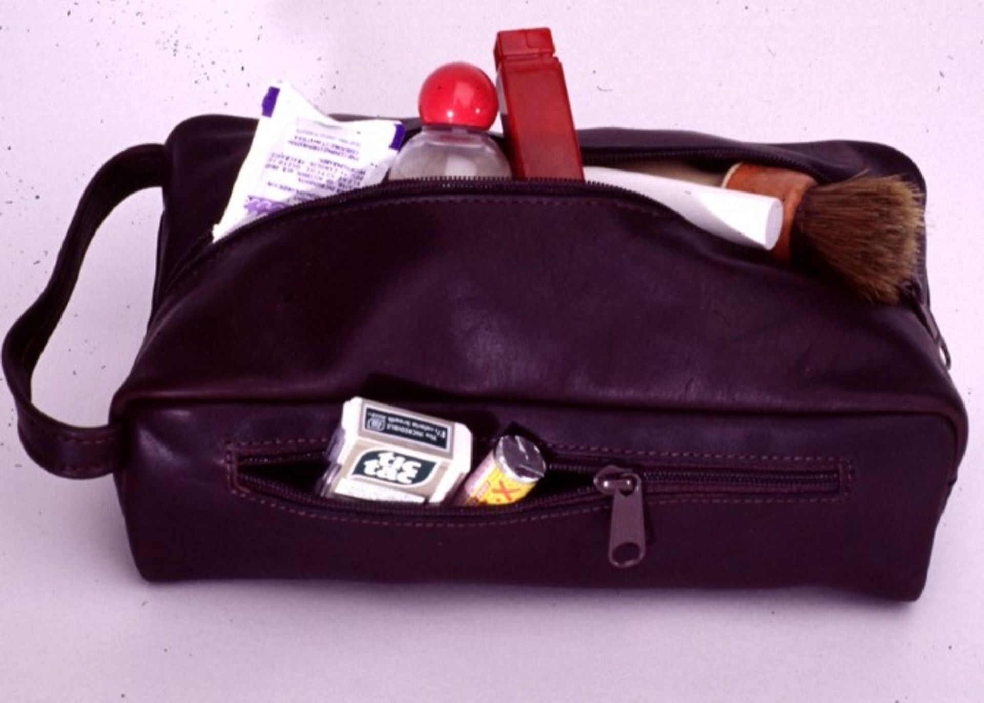 (6) Full grain cowhide travel kit with handle, top & side zipper pockets, folded edges.