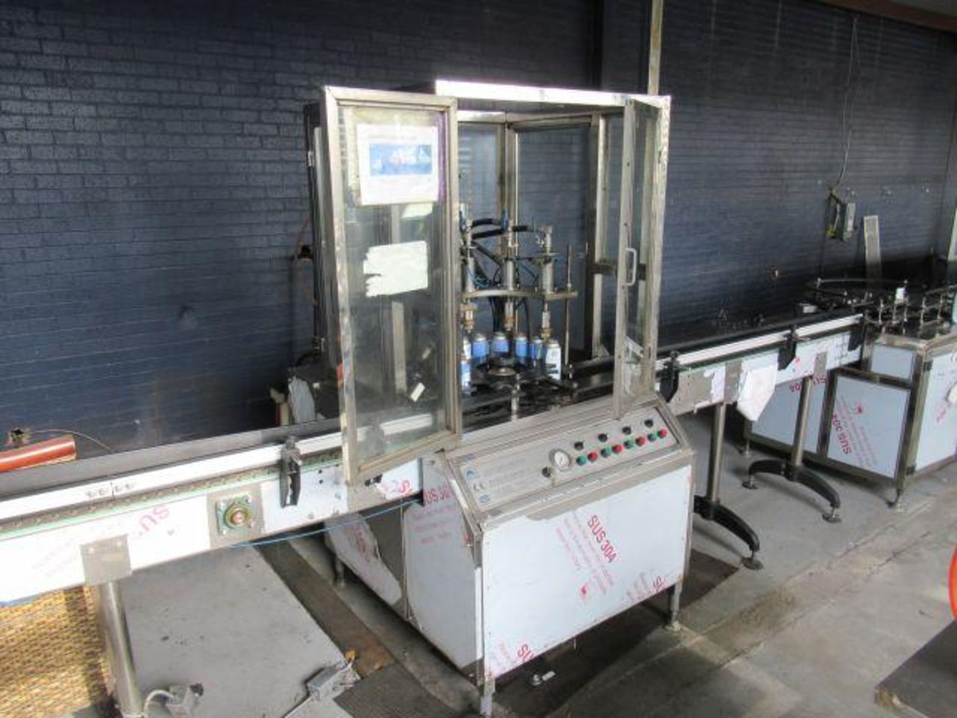 AEROSOL & PROPELLANT PACKAGING LINE 1: Feed table with stainless chain conveyor, Meitar model QGQ