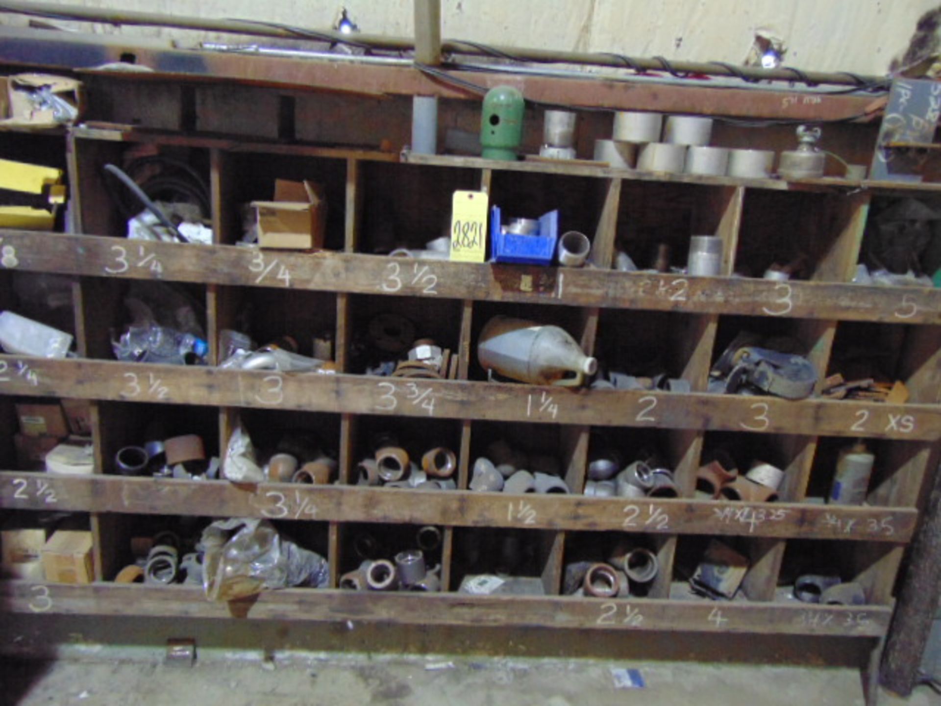 LOT OF PIPE FITTINGS, w/wood rack, assorted