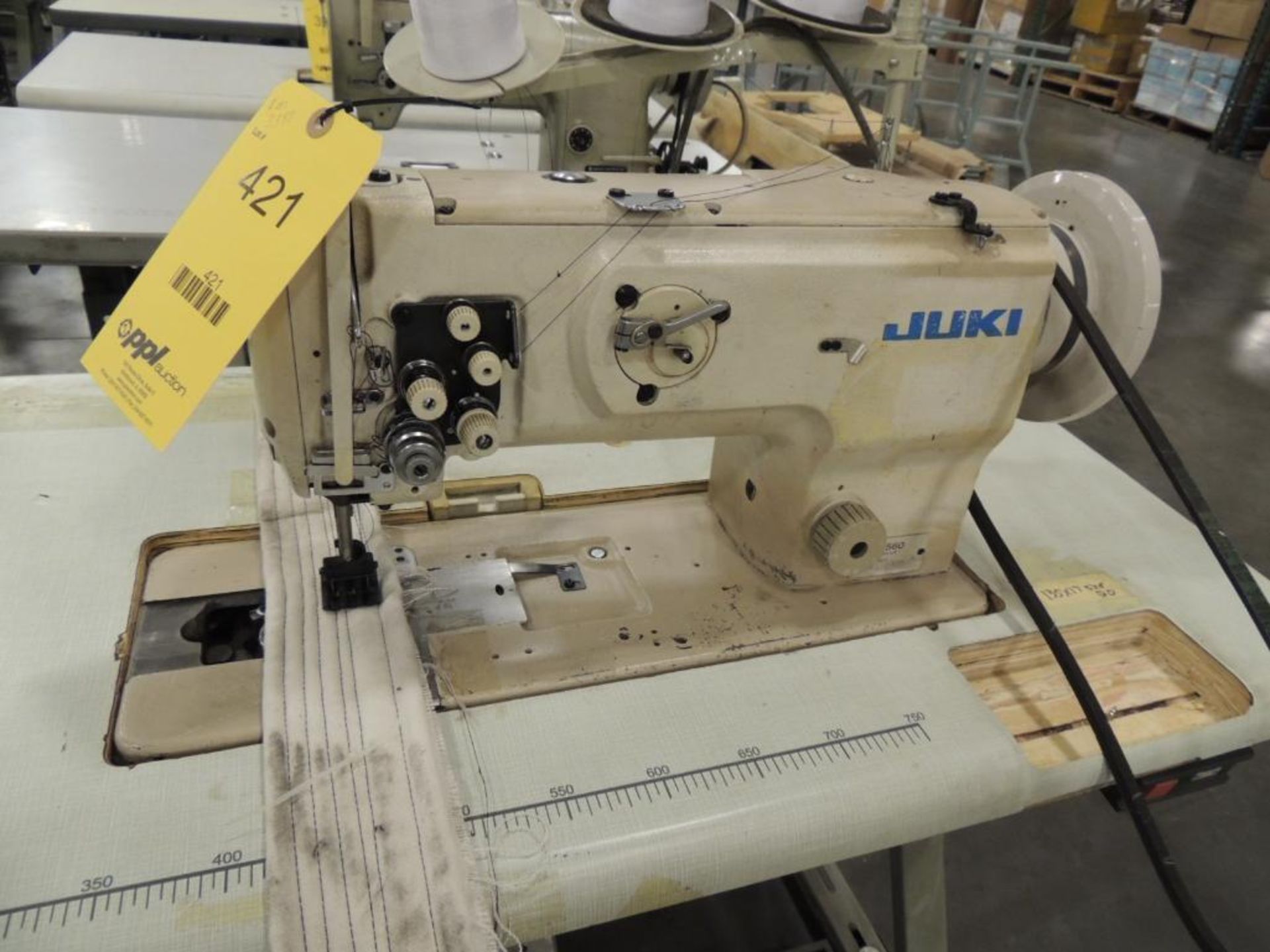 Juki LU-1560 2-Needle, 3-Thread Sewing Machine, on Table