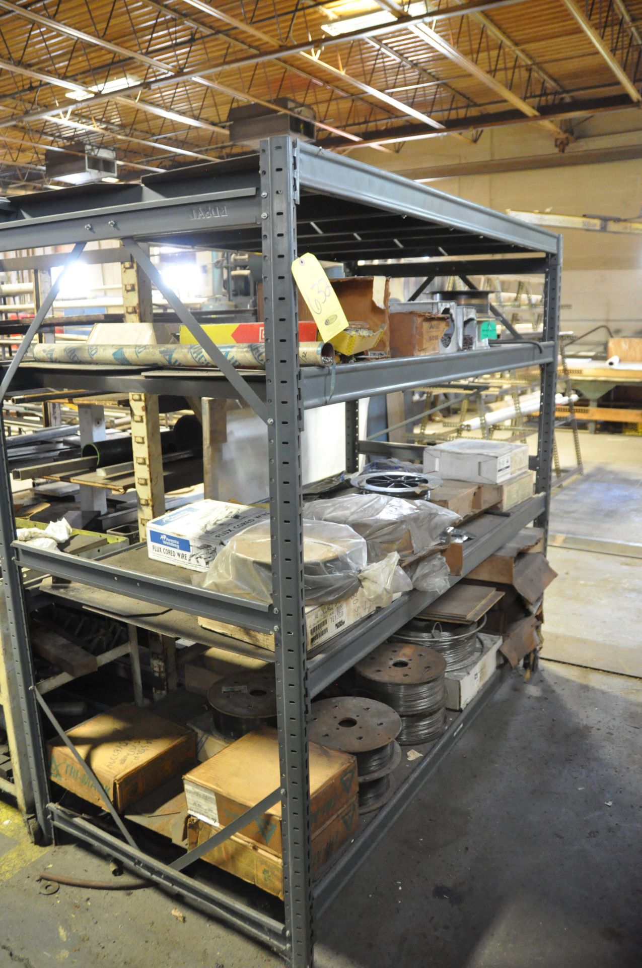 4 SHELF METAL SHELVING UNIT WITH CONTENTS OF WELDING WIRE.