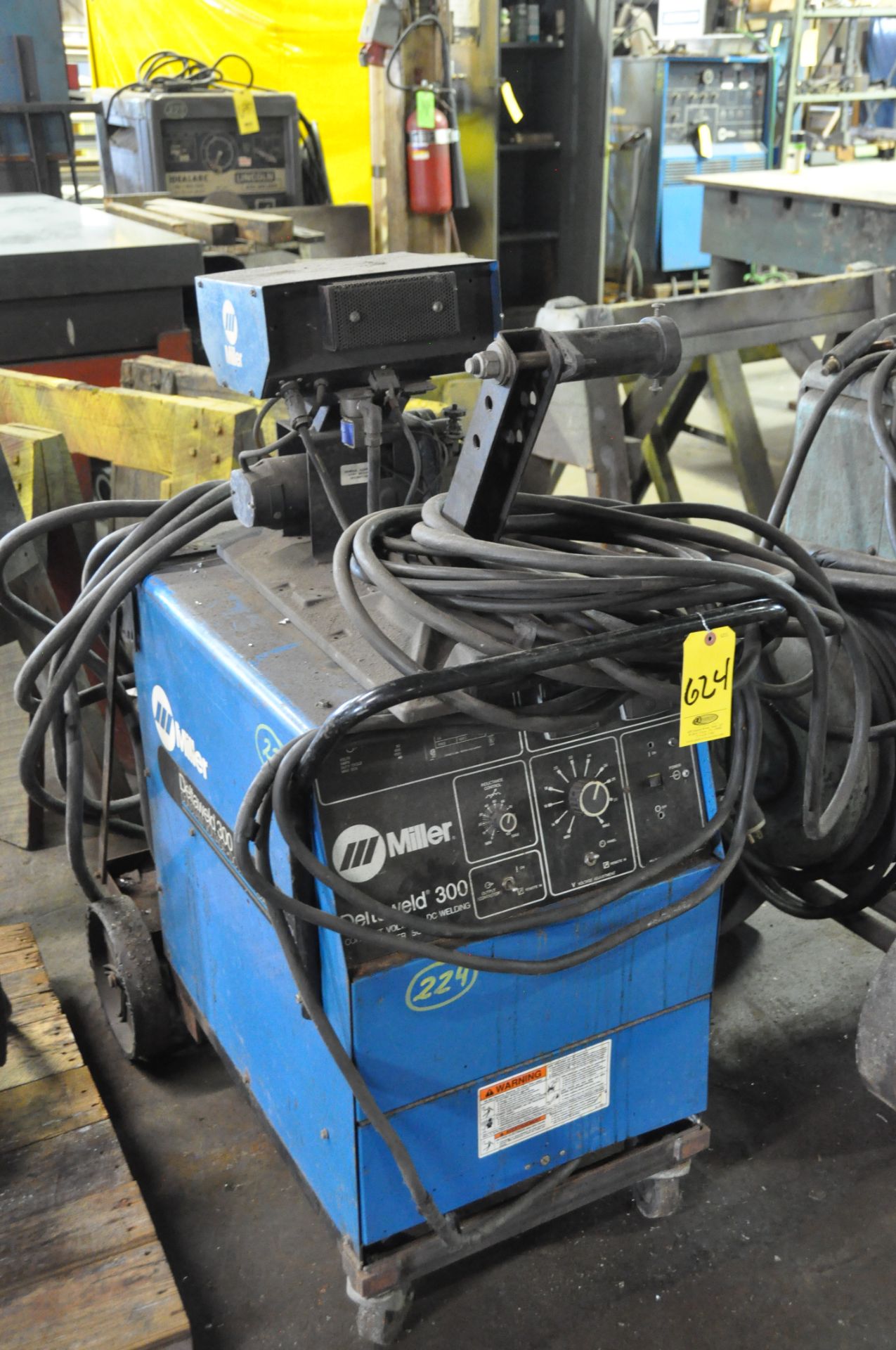 MILLER WELDER WITH MILLER WIRE FEEDER AND MISCANELLOUS CABLES.