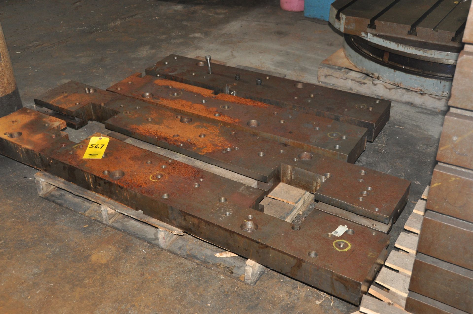 (1) PALLET WITH 4 LARGE MACHINED STEEL PARTS.