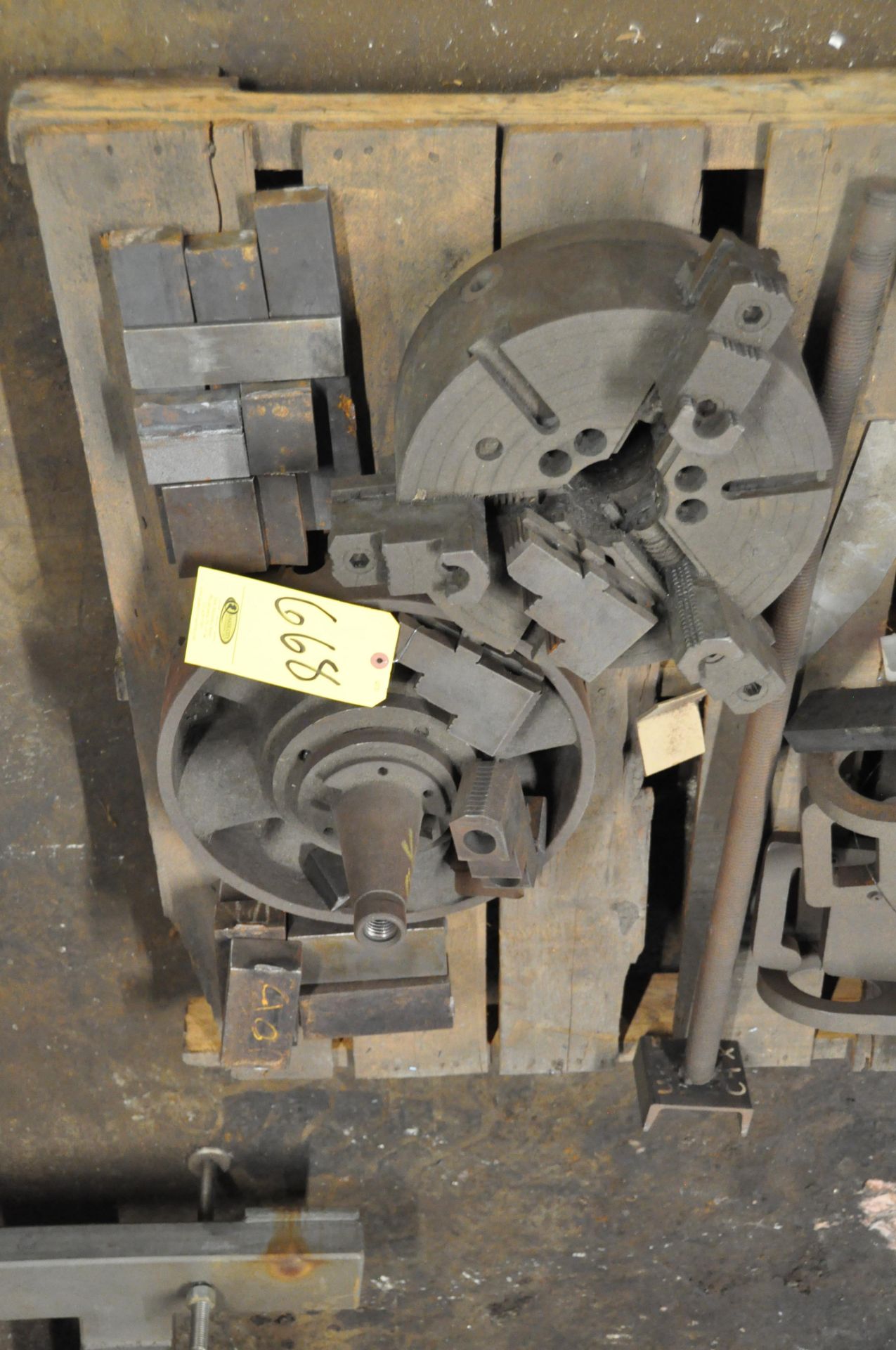(1) 12" 3 JAW CHUCK, (1) 4 JAW CHUCK WITH 50 TAPER TOOL HOLDER BACK ON SKID.