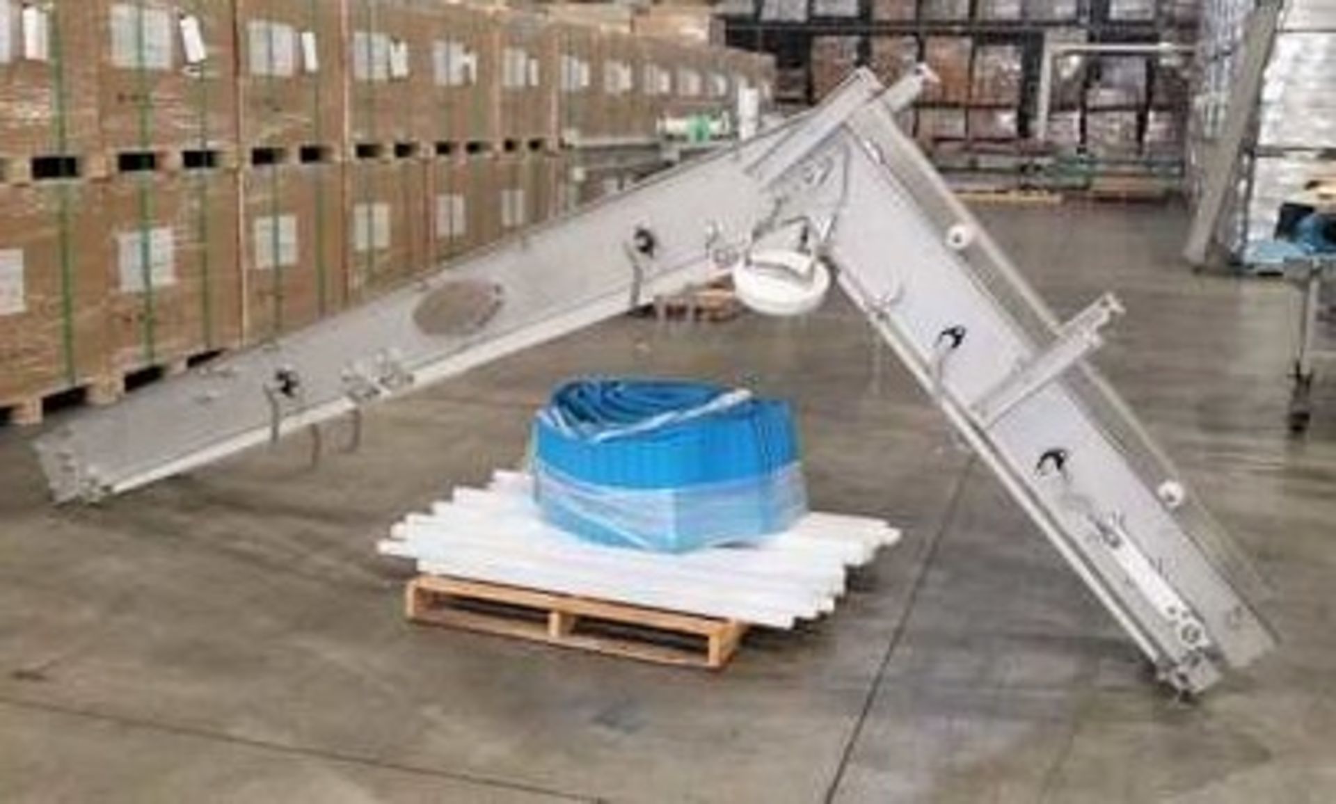 12' High Elevator Conveyor S/S (Shown upside down) with 16" wide belt having 2.5" deep by 2" wide