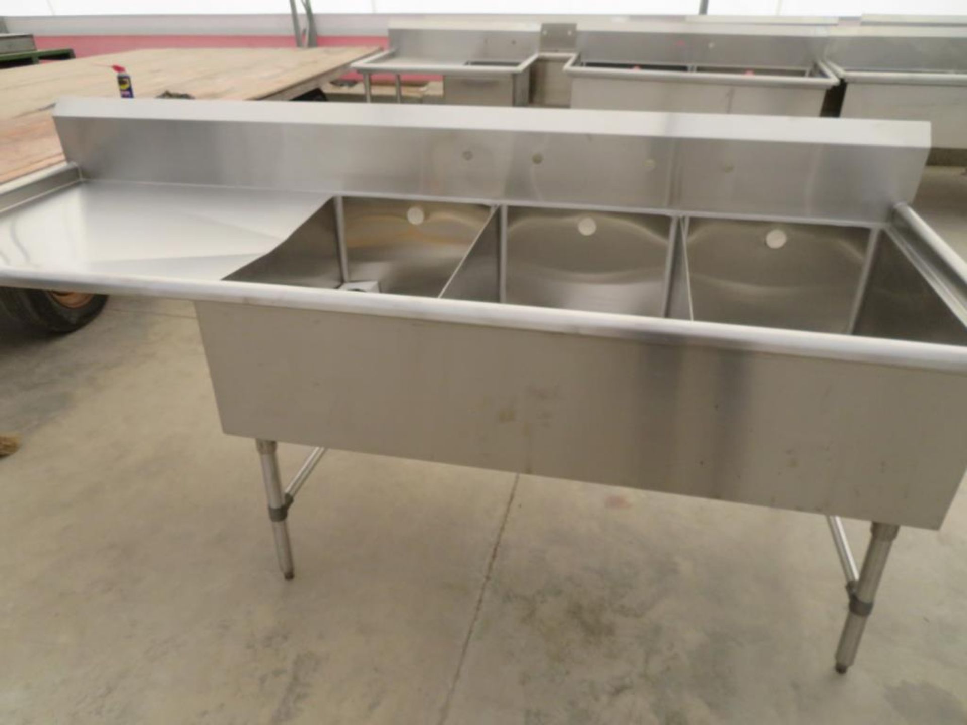 3 compartment sink, 3-20"x30" bowls with 2" overflow holes with 24" drainboard left