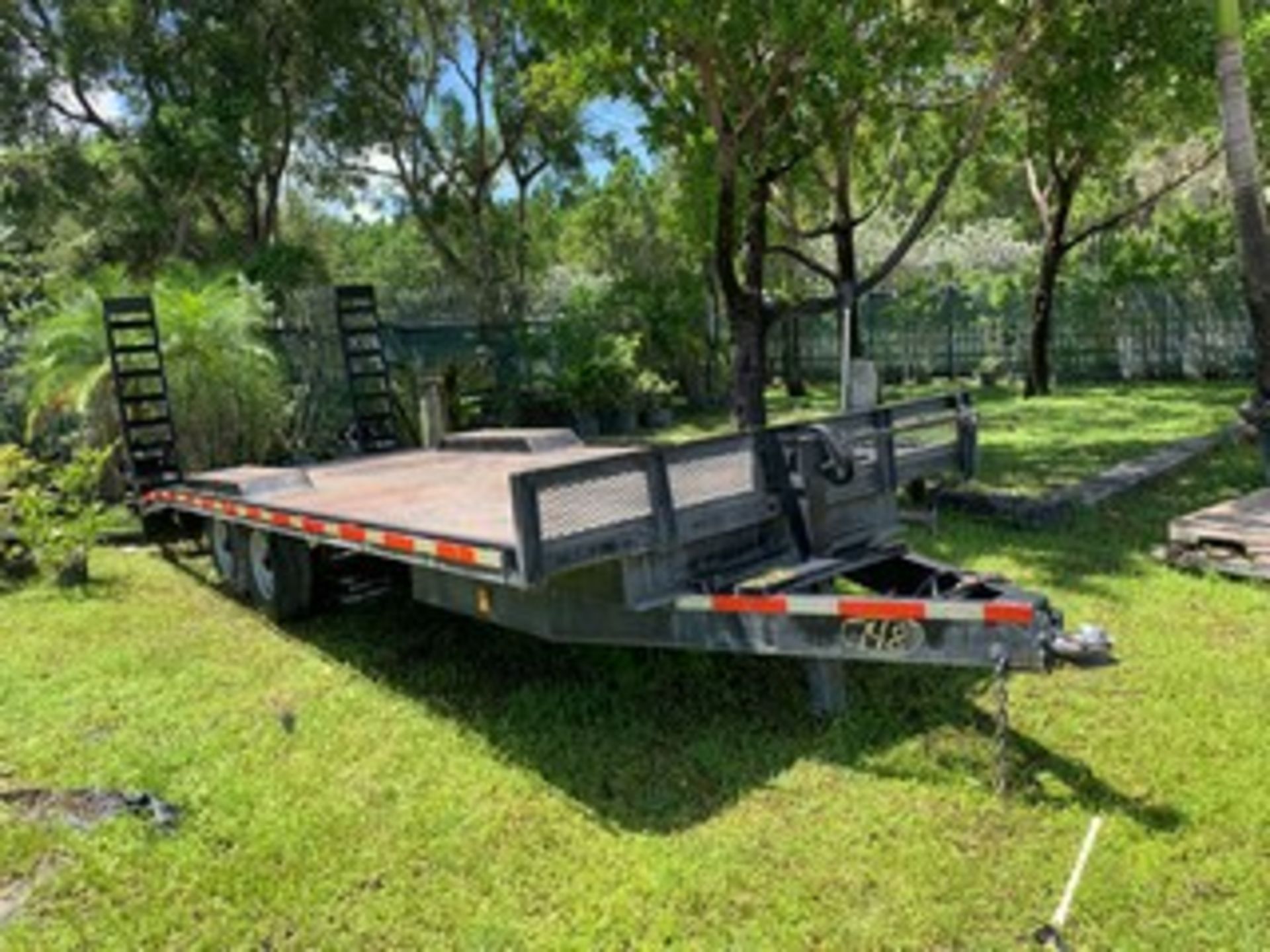 FLATBED TRAILER - BLACK - DUAL AXLE - STEEL DECK - STEEL RAMP - APPROXIMATELY 20'