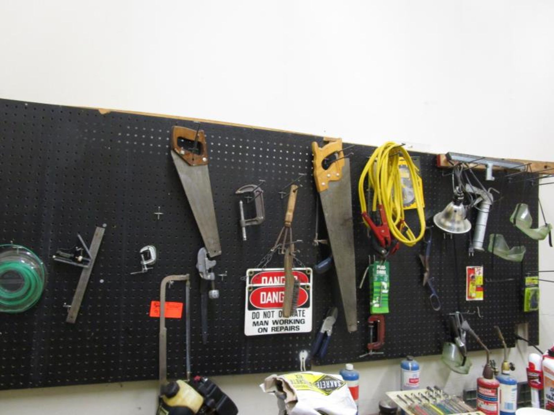 Peg Board Contents: Jumper Cables, Lamp, Saws, Pipe Cutter & Clamp