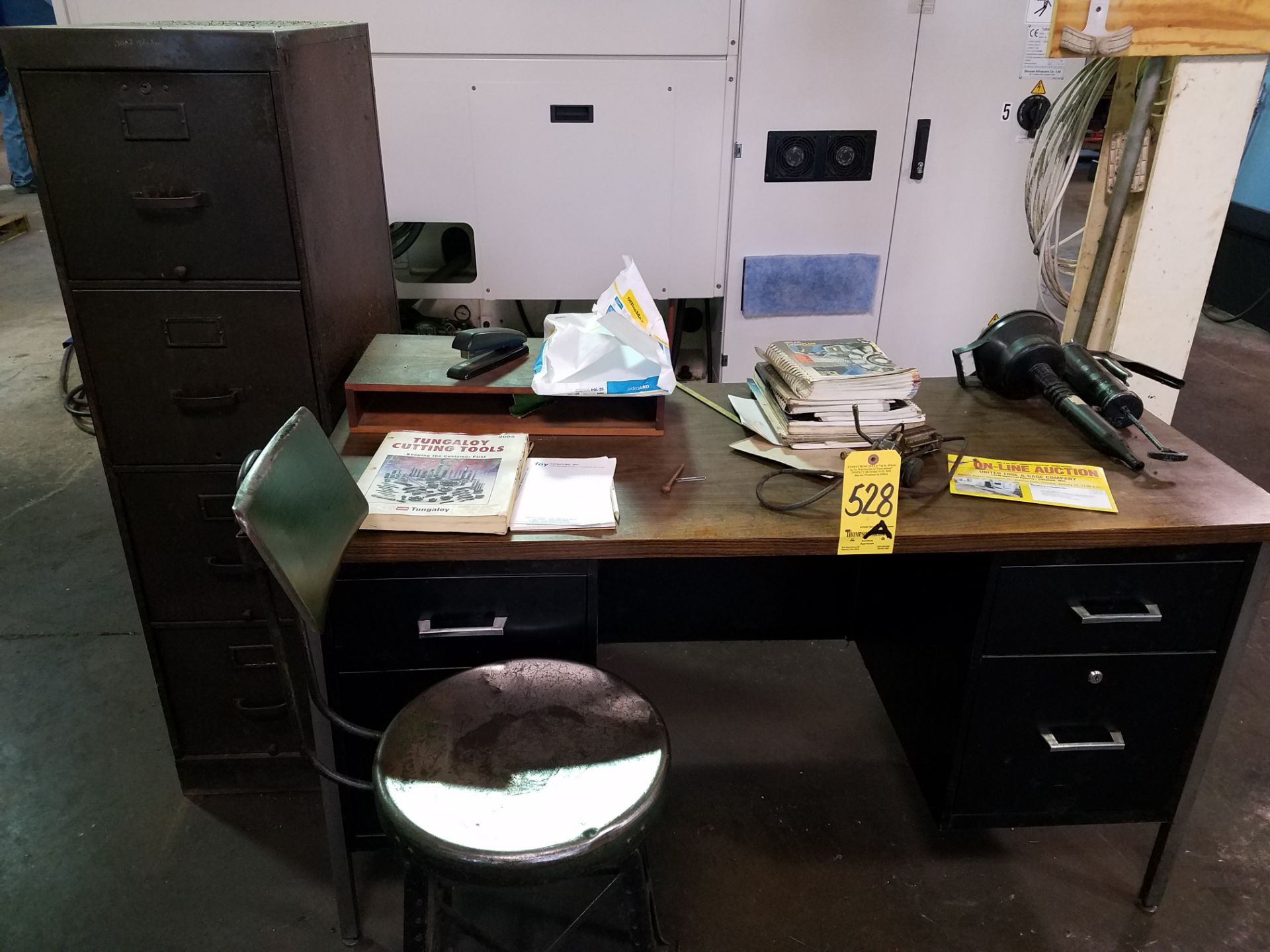 Desk, chair, and file cabinet.