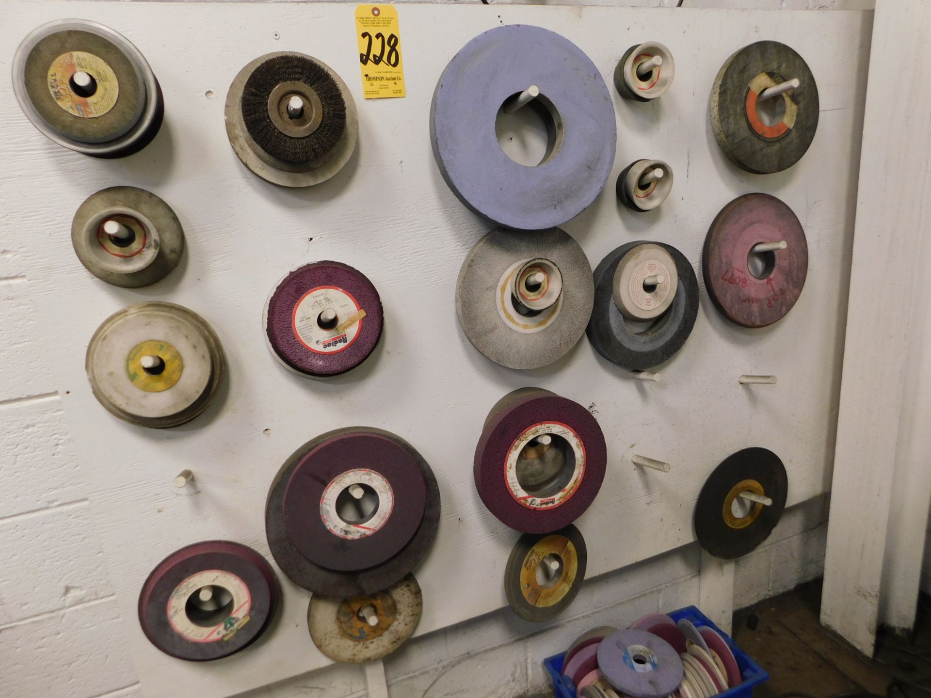 Grinding Wheels Hanging on Wall and in Plastic Tub