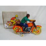 Soviet Russian tinplate motorbike and rider, condition E in E box.