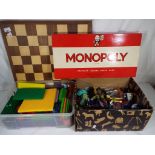 A mixed lot to include Monopoly, wooden chess board, a selection of figures,