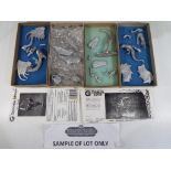 Grenadier Models - Four white metal dragon kits, unassembled and unpainted,