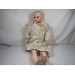 Kestner - A Bisque headed doll, nape of neck marked Made in Germany dep D/3, sleeping eyes,