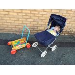 A child's pram with doll and an infant's wooden cart / walker containing coloured wooden blocks [2]