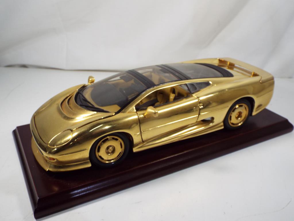 Jaguar - a rare 1:18 scale gold plated Jaguar XJ220 on wooden plinth with original presentation box,