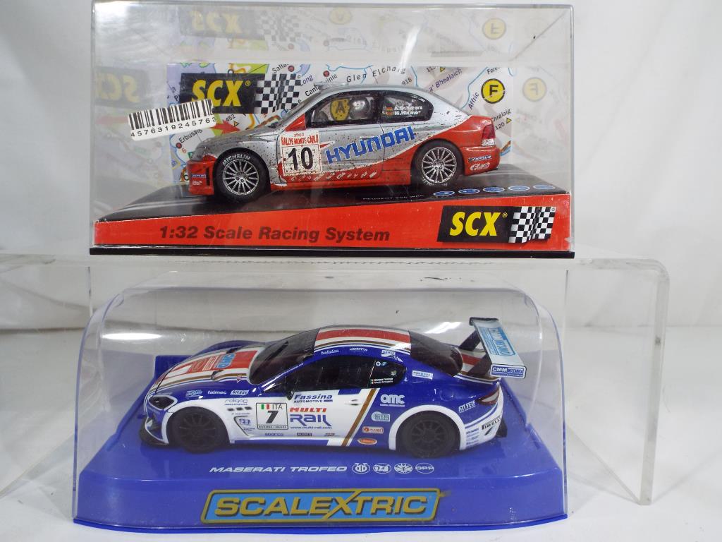 Scalextric - two slot cars comprising Huyndai rally car in associated box and a Maserati Trofeo in