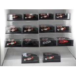 Minichamps - a collection of fourteen Minichamps 1:87 scale F1 cars with a McLaren theme,