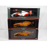 Minichamps - three 1:18 scale diecast F1 cars by Minichamps with a McLaren theme,