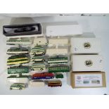 A collection of diecast and pottery model trams and buses to include OO scale resin kits and