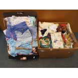 Two boxes containing a large quantity of 1960s and 1970s doll's clothes comprising dresses,