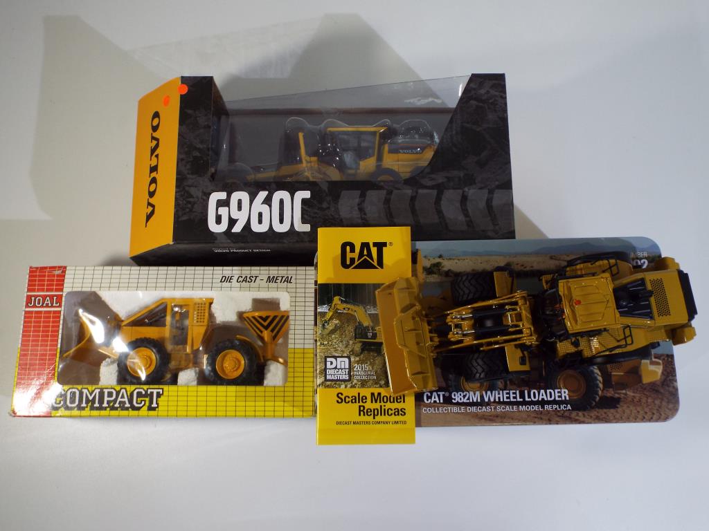 Diecast - three excavators in original boxes, comprising Diecast Masters CAT 982M Wheel Loader,