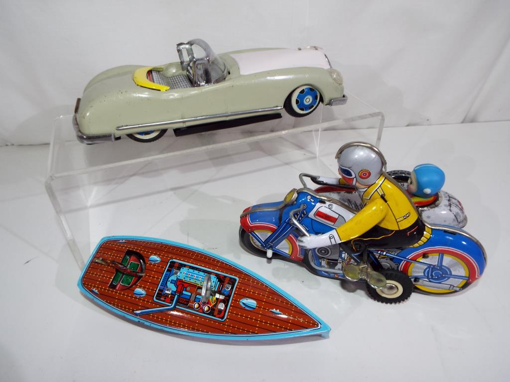 Three vintage tin-plate models comprising - Lucky Open Car friction drive toy car, reg no MF787,