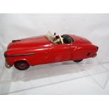 Schuco Combinato 4003 - a tinplate model motor car comprising red body with dark green seats and