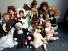 In excess of twelve ceramic faced collectors dolls to include posing babies,