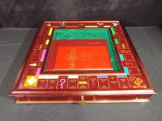 A Franklin Mint Monopoly with 22 carat gold plated pieces appears to be in near mint to mint