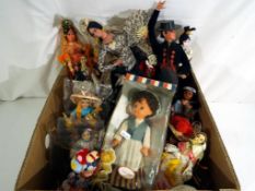 A collection of vintage dolls dressed predominantly in international costumes