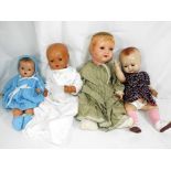 A collection of three composition dolls to include a boy doll marked to the head 133,