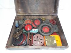A vintage wooden box, containing early Meccano,