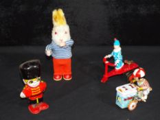 A good mixed lot of clockwork tinplate toys, includes clown, ice cream truck, rabbit and similar,