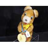 A battery operated mechanical bear playing a drum, marked made in Korea.