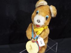 A battery operated mechanical bear playing a drum, marked made in Korea.