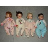 A collection of four Ashton Drake soft bodied dolls dressed in various Warner Bros.