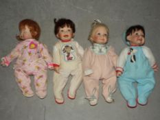 A collection of four Ashton Drake soft bodied dolls dressed in various Warner Bros.