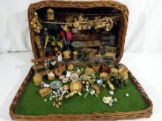 A wicker basket containing a diorama of a flower shop with displays of wicker baskets, flowers,